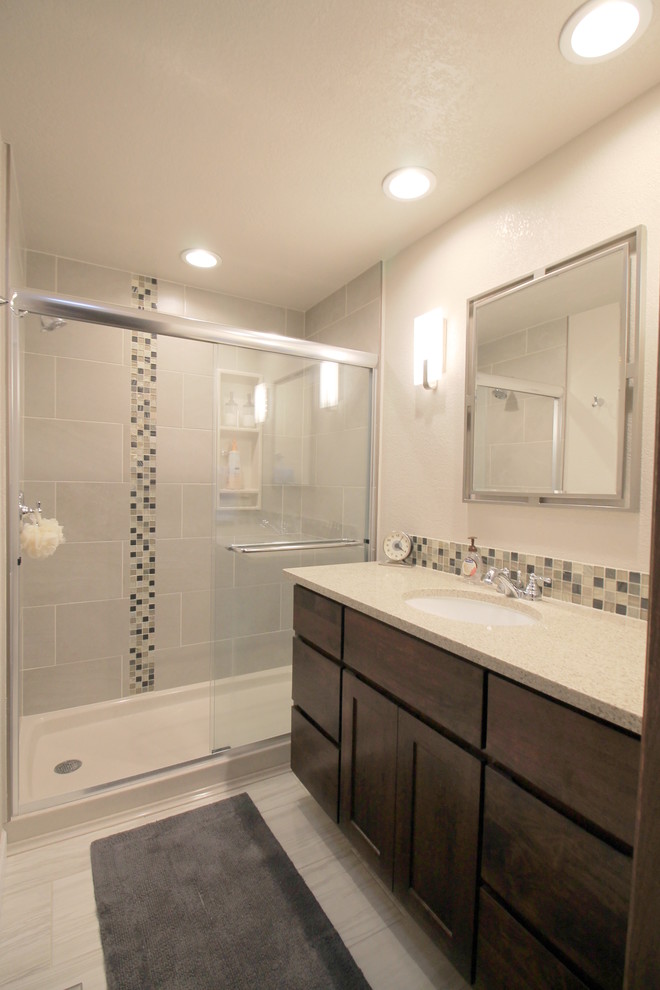 Mid-sized contemporary 3/4 bathroom in Seattle with flat-panel cabinets, dark wood cabinets, an alcove shower, a two-piece toilet, beige tile, black tile, blue tile, brown tile, mosaic tile, beige walls, ceramic floors, an undermount sink, laminate benchtops, grey floor and a sliding shower screen.