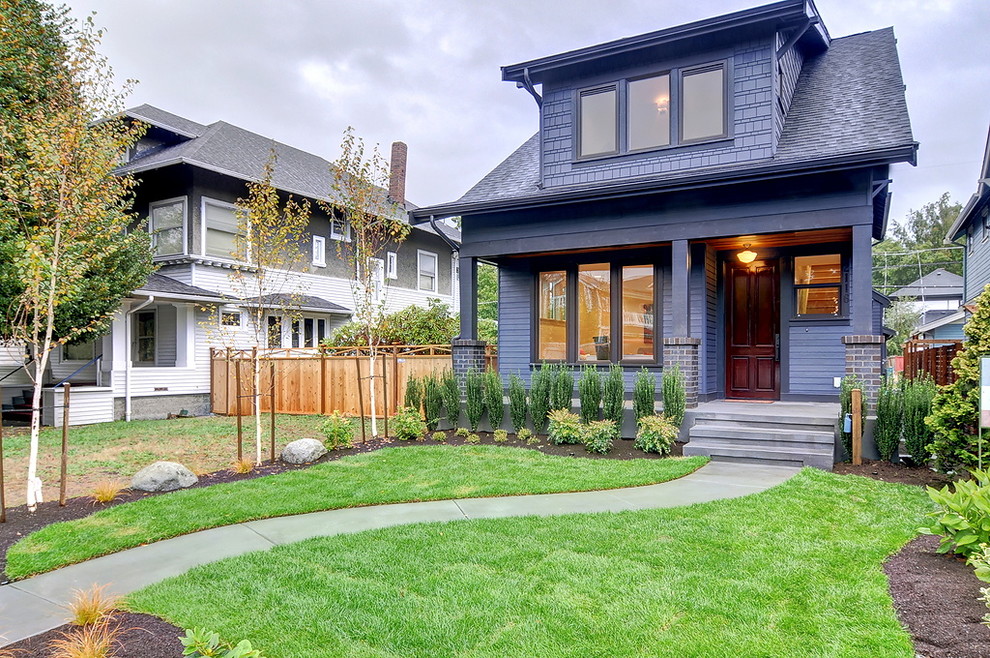 Design ideas for an arts and crafts two-storey blue house exterior in Seattle with a gable roof and a shingle roof.