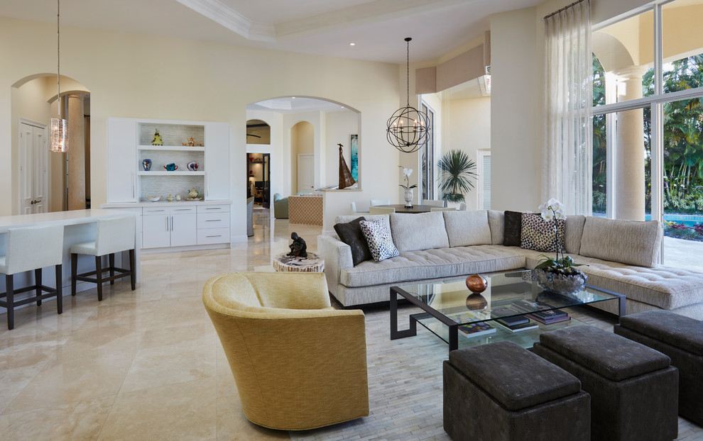 Photo of a large transitional open concept living room in Miami with a home bar, beige walls, marble floors and beige floor.