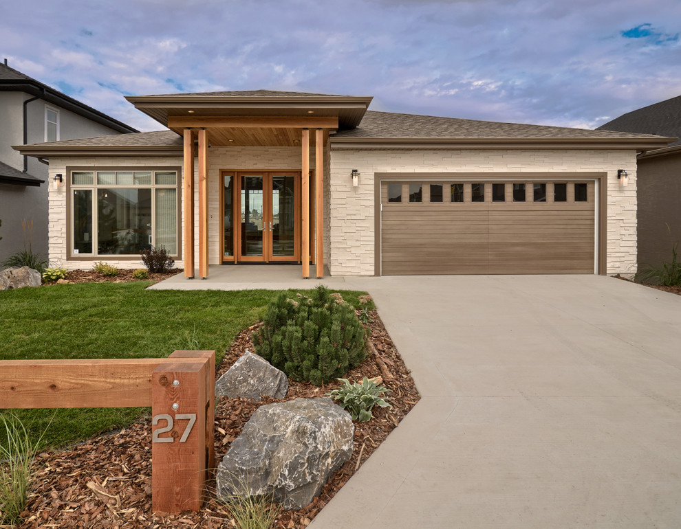 Photo of a contemporary one-storey exterior in Other with stone veneer.