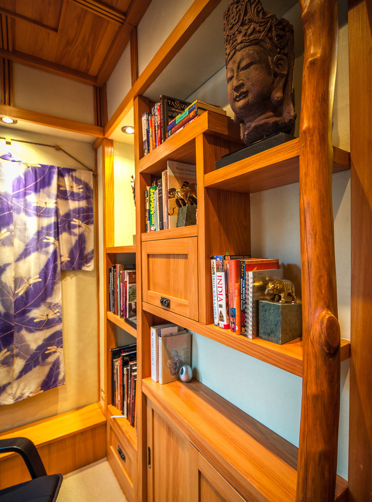 This is an example of a small asian study room in Chicago with green walls, dark hardwood floors, no fireplace and a built-in desk.