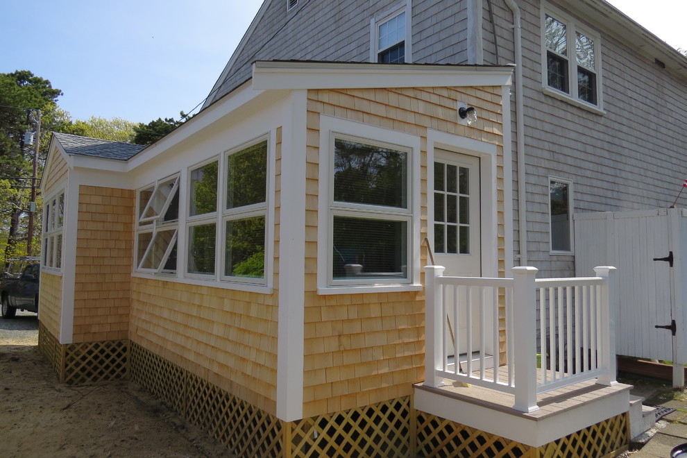 Photo of a mid-sized traditional two-storey grey house exterior in Boston with mixed siding and a hip roof.
