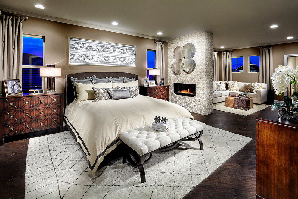 Inspiration for a mid-sized contemporary master bedroom in Denver with beige walls, dark hardwood floors, a two-sided fireplace and a stone fireplace surround.