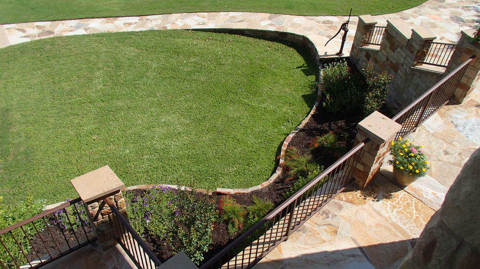 Design ideas for a mediterranean front yard verandah in Austin with natural stone pavers.