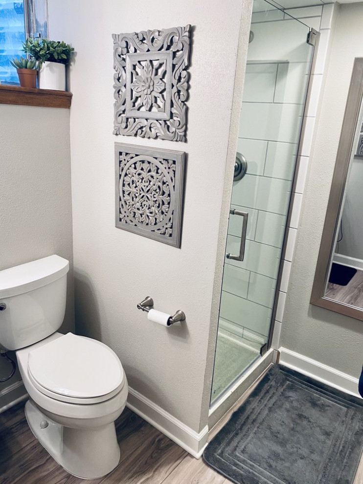 Small contemporary 3/4 bathroom in Other with shaker cabinets, grey cabinets, a two-piece toilet, white tile, subway tile, grey walls, laminate floors, an undermount sink, marble benchtops, multi-coloured floor, yellow benchtops, a single vanity and a freestanding vanity.