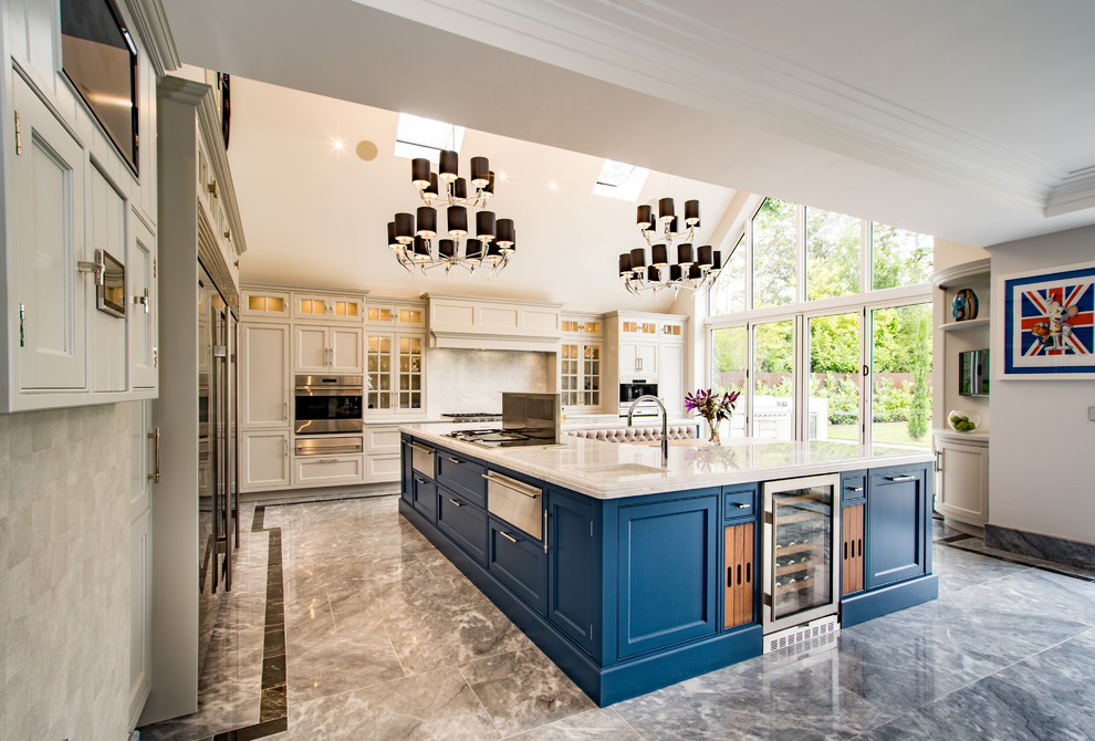 This is an example of an expansive contemporary l-shaped kitchen in Buckinghamshire with recessed-panel cabinets, beige cabinets, an island, grey floors, white worktops, marble worktops and marble flooring.