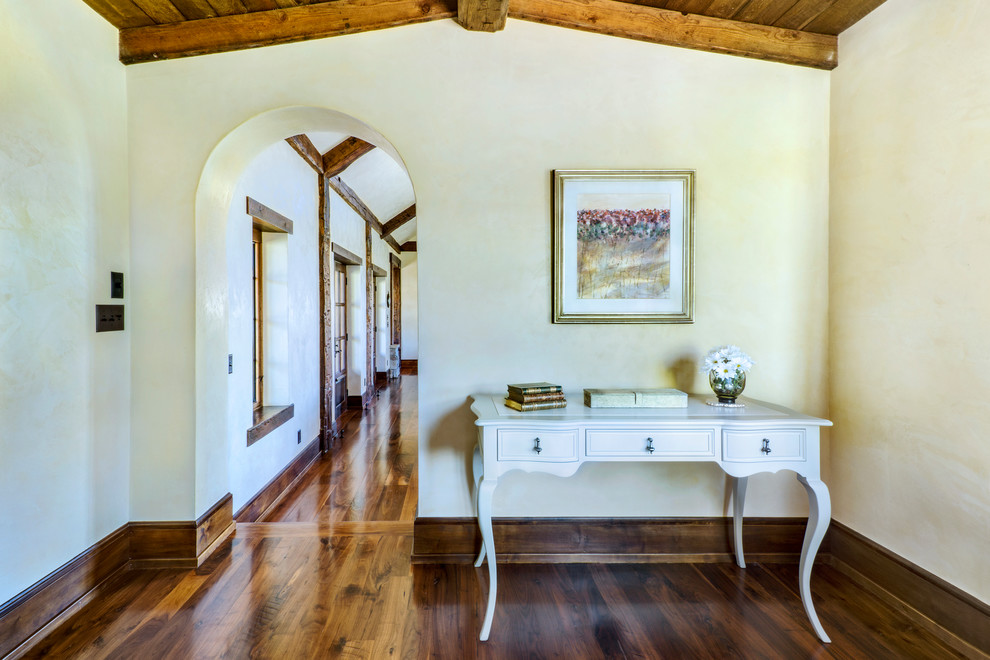 Example of a mid-sized mountain style medium tone wood floor hallway design with beige walls