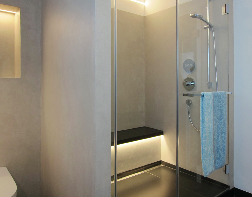 Inspiration för mellanstora moderna grått badrum med dusch, med släta luckor, skåp i mörkt trä, en dusch i en alkov, en vägghängd toalettstol, grå kakel, vita väggar, klinkergolv i keramik, ett fristående handfat och svart golv