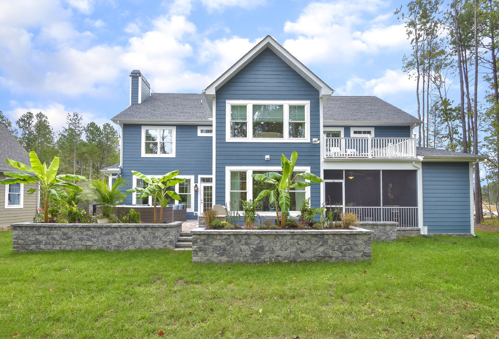 Photo of a contemporary blue house exterior in Richmond with vinyl siding and a gable roof.