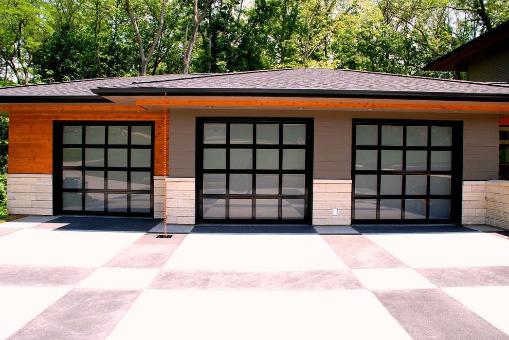 Design ideas for a large contemporary attached three-car garage in Cedar Rapids.