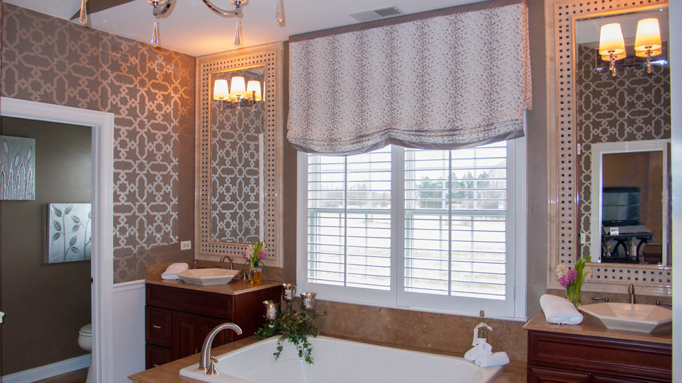 Example of a transitional master porcelain tile drop-in bathtub design in Chicago with raised-panel cabinets, dark wood cabinets, beige walls and a vessel sink