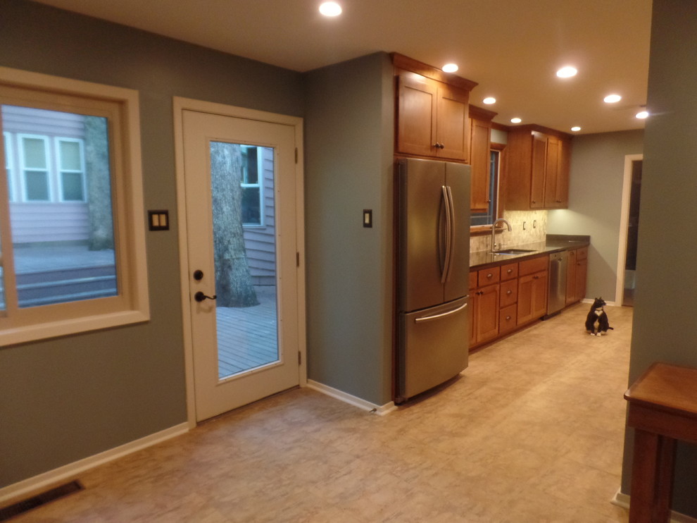 Inspiration for a mid-sized transitional galley eat-in kitchen remodel with an undermount sink, shaker cabinets, medium tone wood cabinets, quartz countertops, multicolored backsplash, travertine backsplash, colored appliances and no island