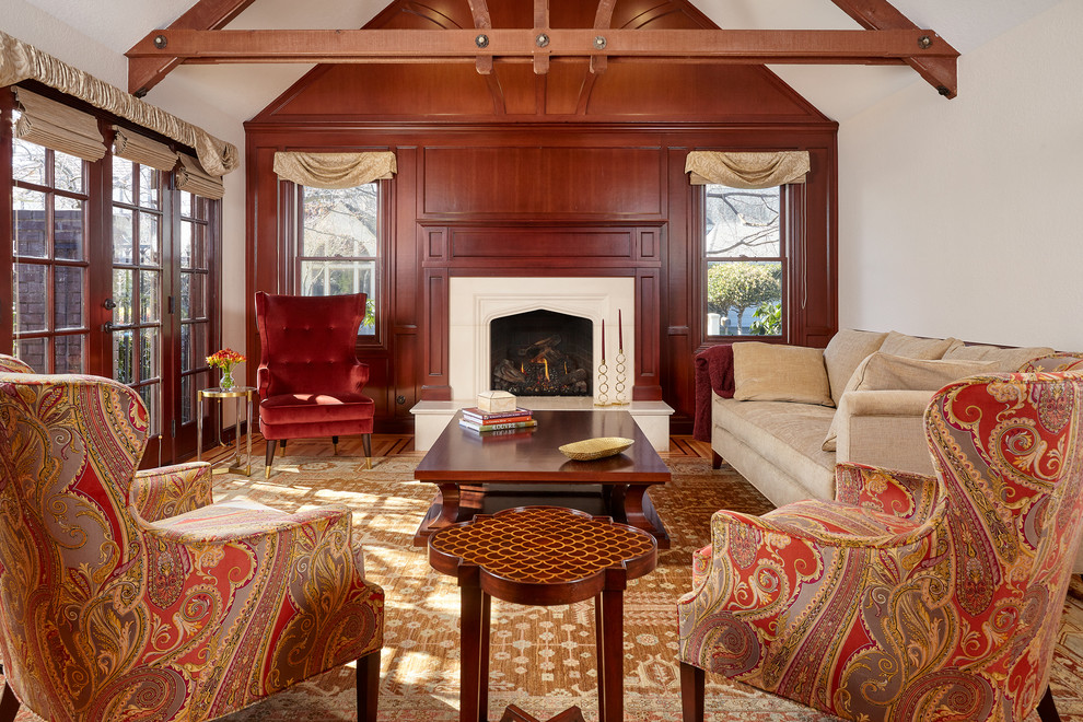 Photo of a mid-sized traditional formal enclosed living room in San Francisco with a standard fireplace, a plaster fireplace surround, no tv, beige walls, medium hardwood floors and brown floor.