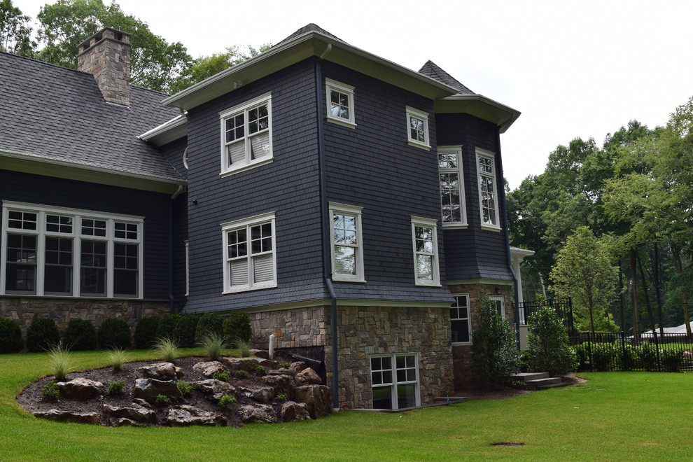 Inspiration for a large traditional two-storey blue exterior in New York with stone veneer.