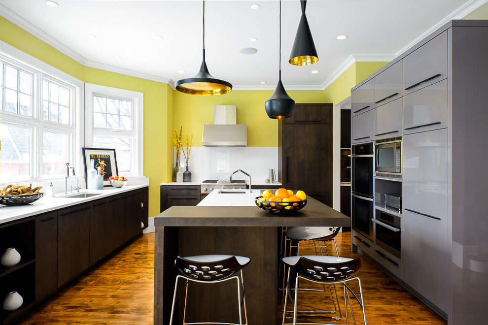 Photo of a contemporary kitchen in Ottawa with grey cabinets and medium hardwood floors.