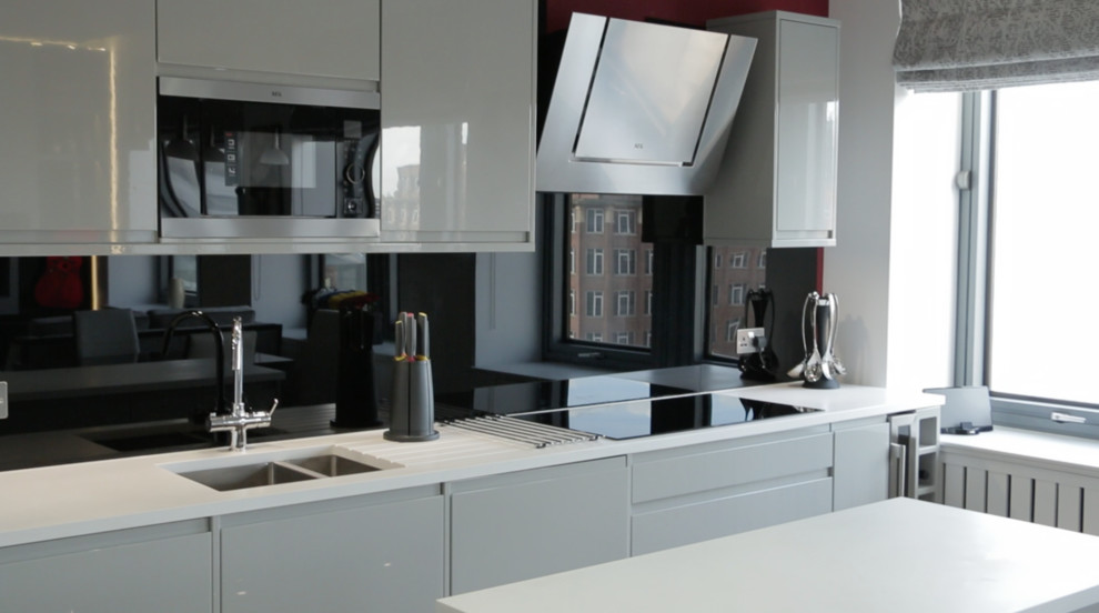 Photo of a small modern kitchen in London with with island.