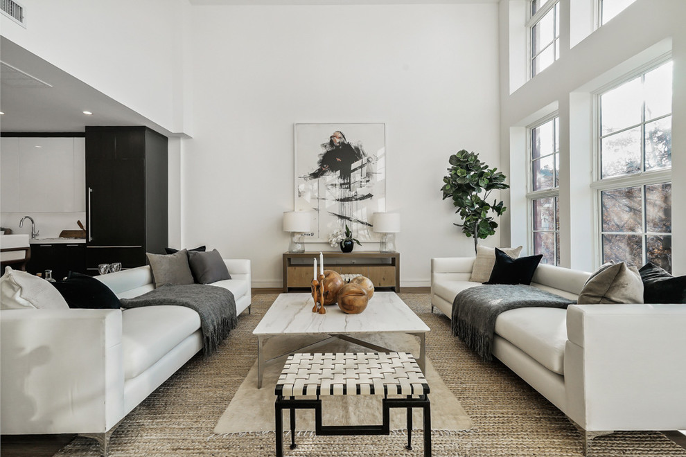 Inspiration for a transitional living room in New York with white walls, medium hardwood floors and brown floor.