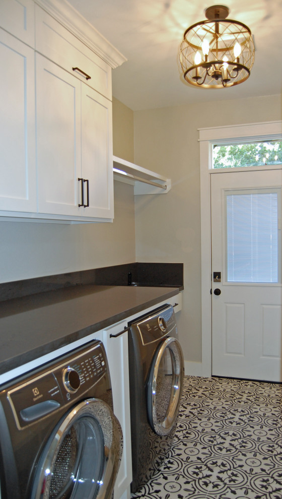 Mid-sized country galley utility room in Houston with shaker cabinets, white cabinets, quartz benchtops, grey walls, ceramic floors, an integrated washer and dryer, white floor and grey benchtop.