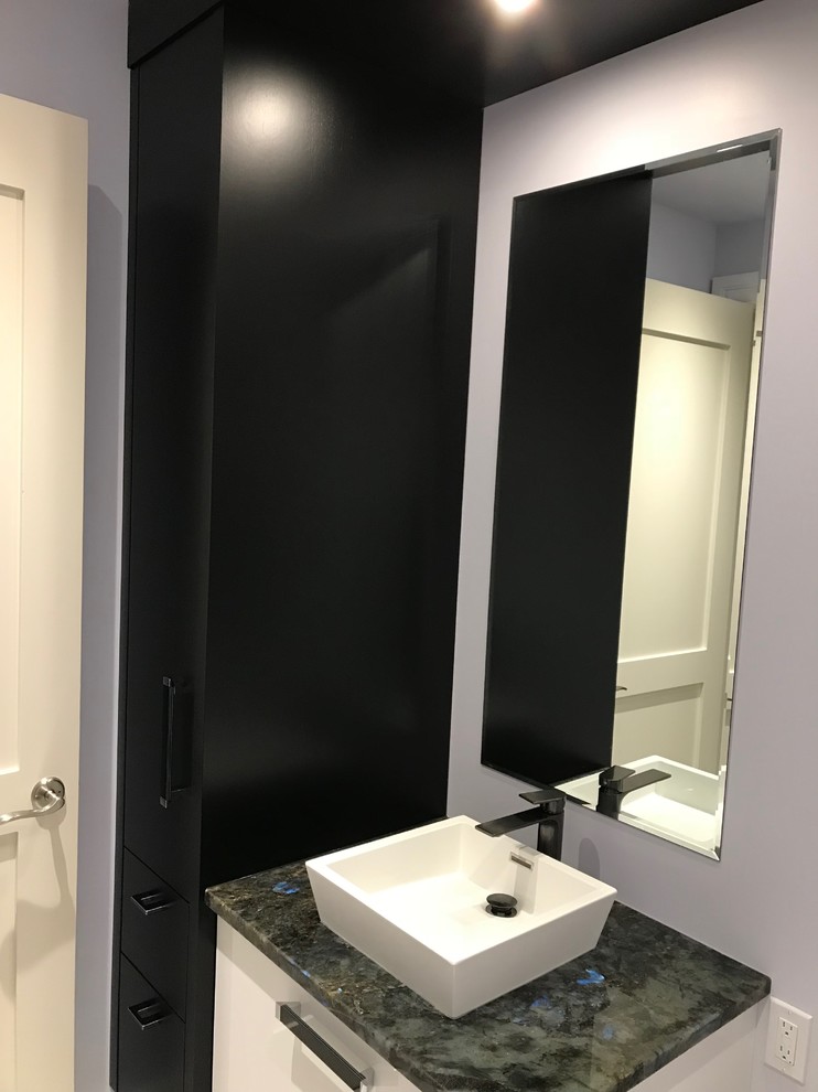 Inspiration for a small modern powder room in Calgary with flat-panel cabinets, white cabinets, a two-piece toilet, purple walls, ceramic floors, a pedestal sink, granite benchtops and beige floor.