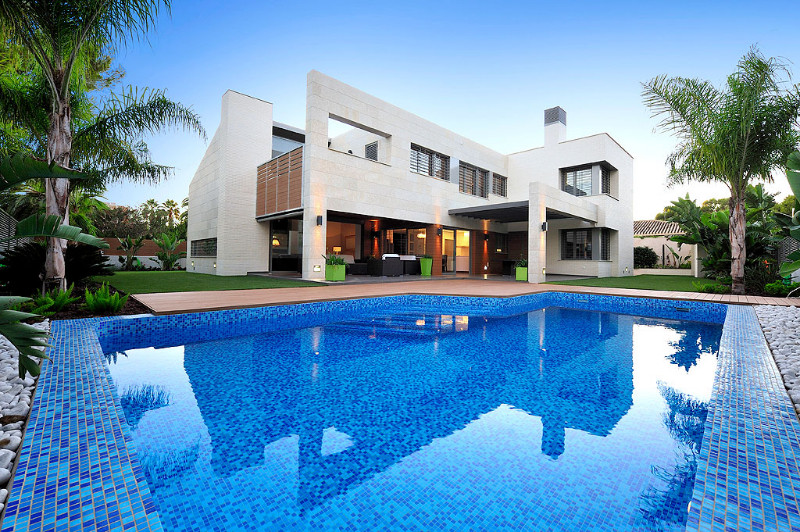 Photo of a mid-sized contemporary front yard custom-shaped lap pool in Other with a pool house.