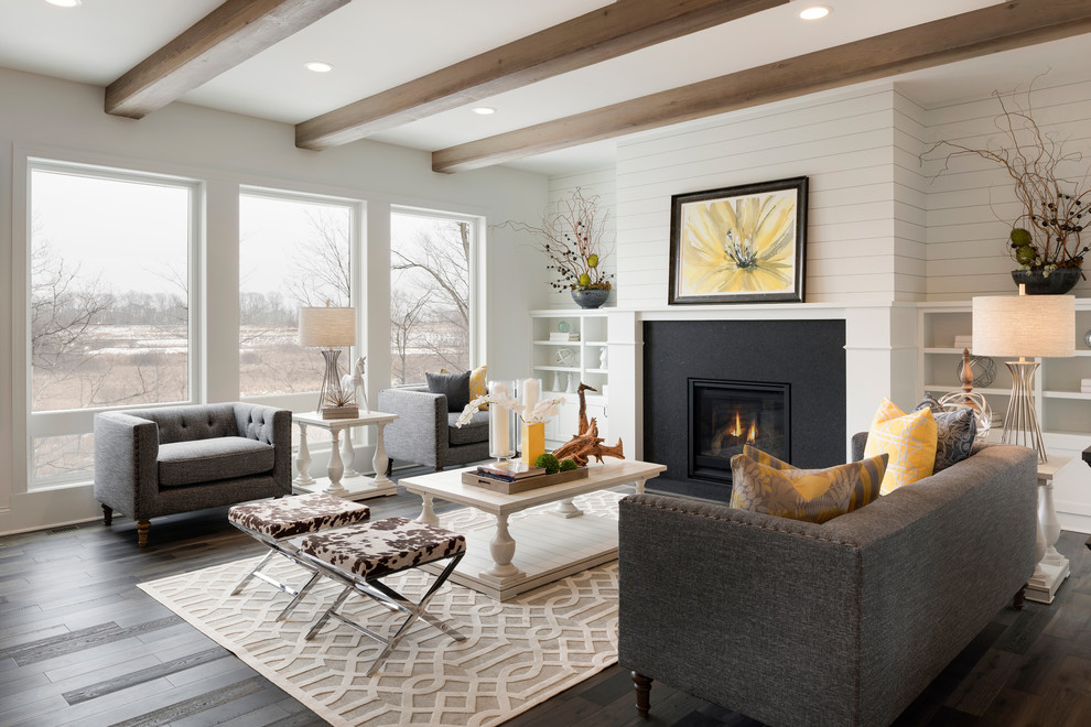 Photo of a transitional living room in New York with white walls, dark hardwood floors, a standard fireplace and brown floor.