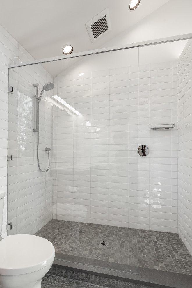 This is an example of a large contemporary 3/4 bathroom in Seattle with flat-panel cabinets, black cabinets, an open shower, a one-piece toilet, white tile, ceramic tile, ceramic floors, an undermount sink, engineered quartz benchtops, grey floor, an open shower and white benchtops.