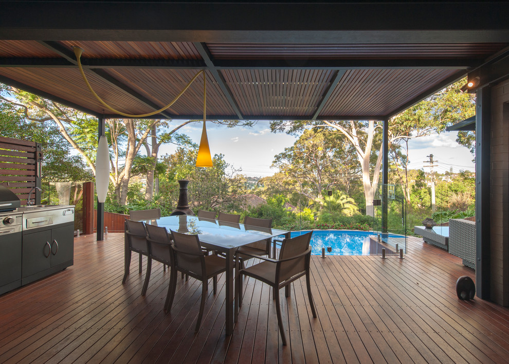 This is an example of a contemporary deck in Sydney with a roof extension.