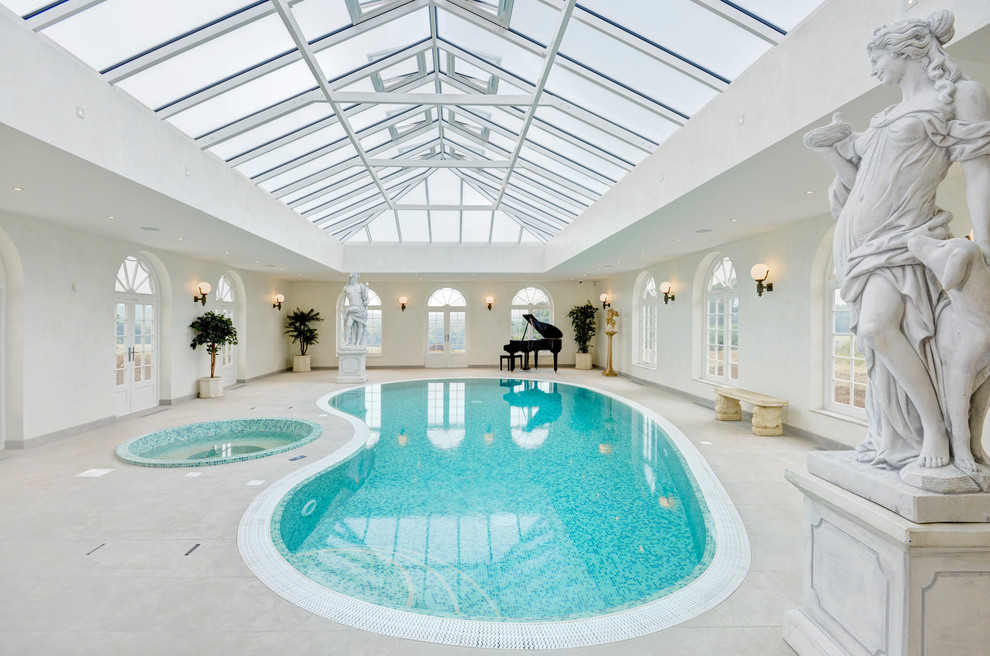 Large traditional indoor kidney-shaped pool in Hertfordshire.