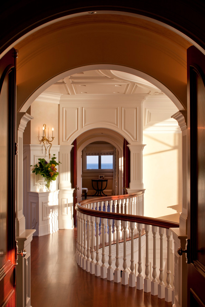 Design ideas for a mid-sized traditional hallway in Portland Maine with beige walls and dark hardwood floors.