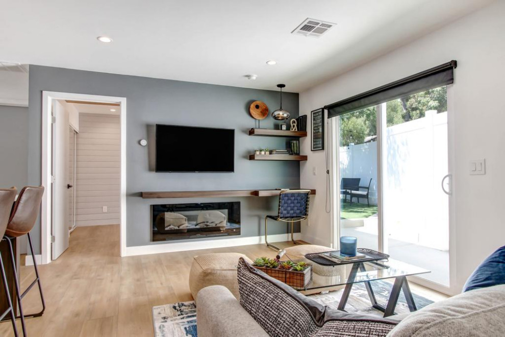 Inspiration for a small transitional open concept vinyl floor, brown floor, wallpaper ceiling and wallpaper family room remodel in Los Angeles with white walls, a ribbon fireplace, a concrete fireplace and a wall-mounted tv