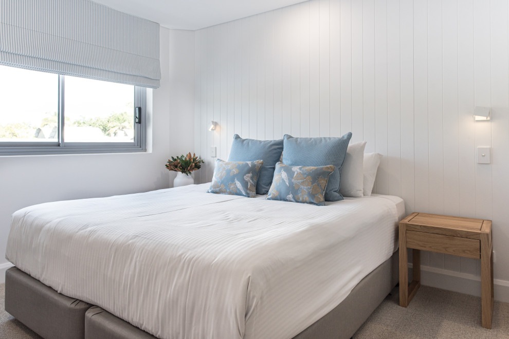 Design ideas for a small beach style master bedroom in Sunshine Coast with white walls, carpet and beige floor.