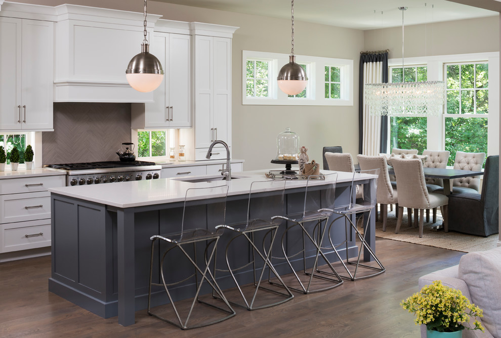 Inspiration for a large transitional dark wood floor and brown floor open concept kitchen remodel in Minneapolis with an undermount sink, shaker cabinets, white cabinets, gray backsplash, stainless steel appliances and an island