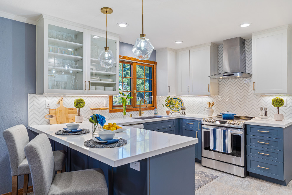 Mid-sized transitional u-shaped kitchen pantry in San Francisco with a single-bowl sink, shaker cabinets, white cabinets, quartz benchtops, blue splashback, glass tile splashback, stainless steel appliances, vinyl floors, a peninsula, blue floor and white benchtop.