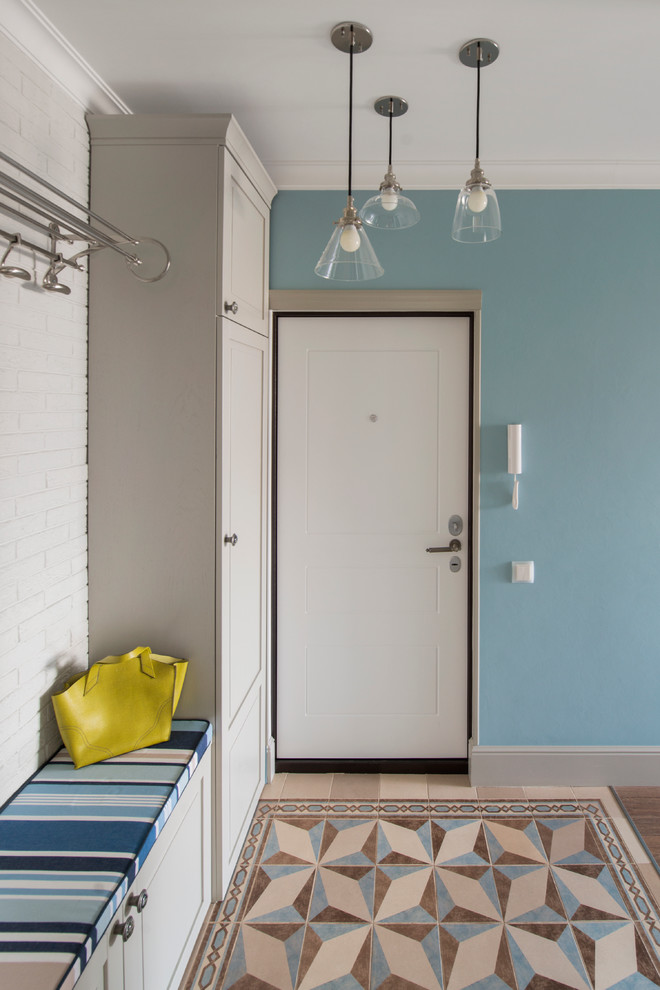 This is an example of a contemporary entryway in Moscow with blue walls, a single front door and a white front door.