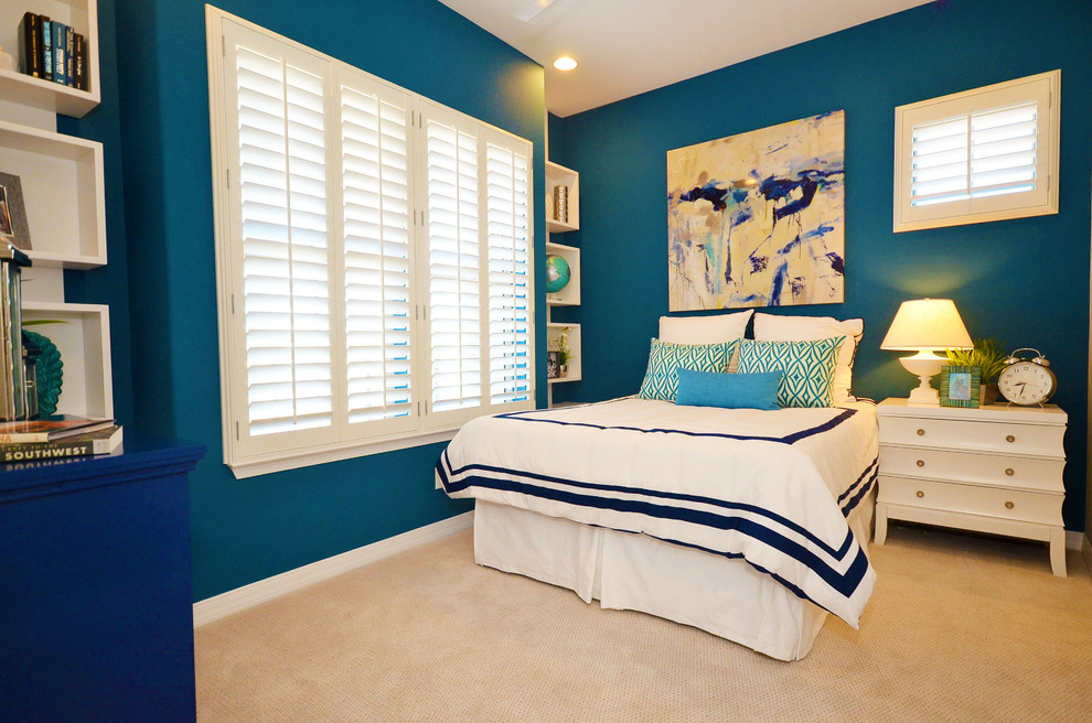 This is an example of a mid-sized transitional kids' room for girls in Phoenix with blue walls and carpet.