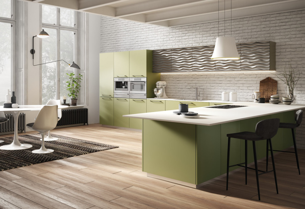Foto di una grande cucina a L minimalista con ante verdi, paraspruzzi in mattoni, elettrodomestici in acciaio inossidabile, parquet chiaro e top bianco