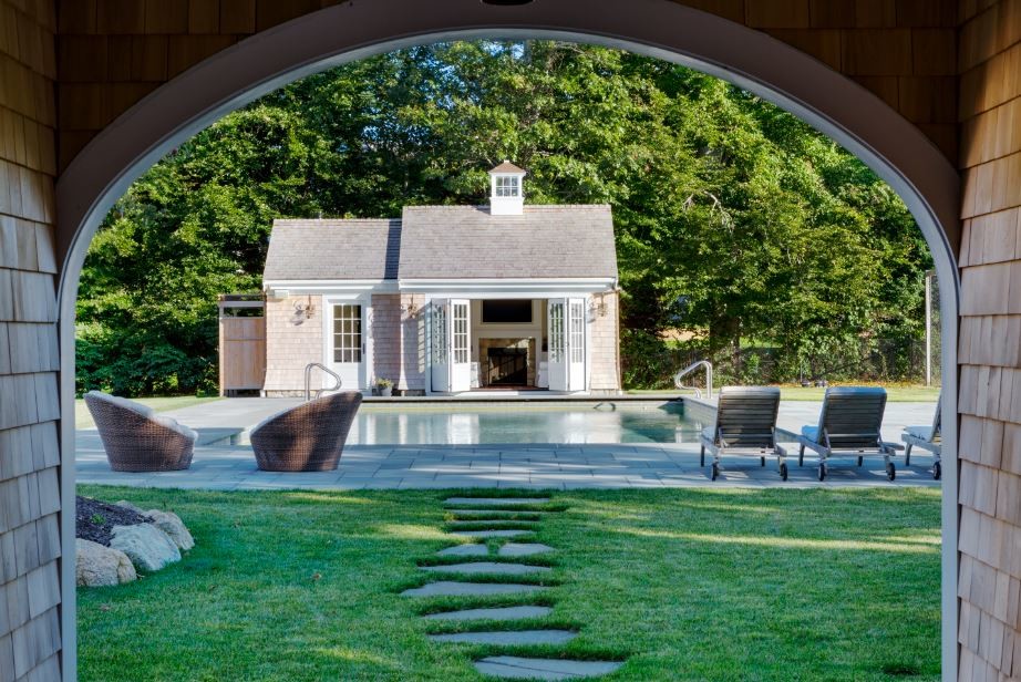 Example of a mid-sized backyard tile and rectangular pool design in Boston