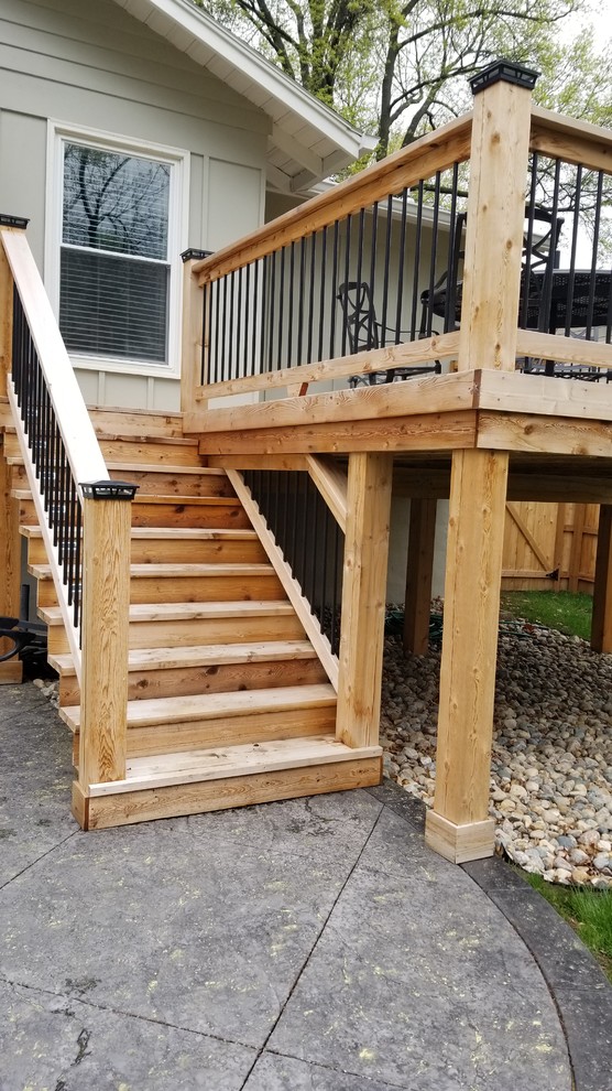This is an example of a mid-sized traditional backyard deck in Kansas City with no cover.