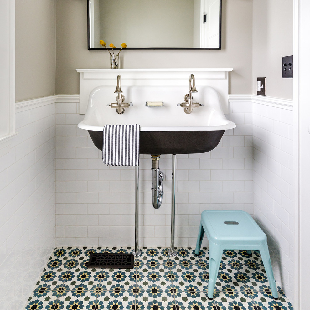 Photo of a small traditional powder room in Chicago with white tile, cement tiles, a wall-mount sink, subway tile, grey walls and multi-coloured floor.