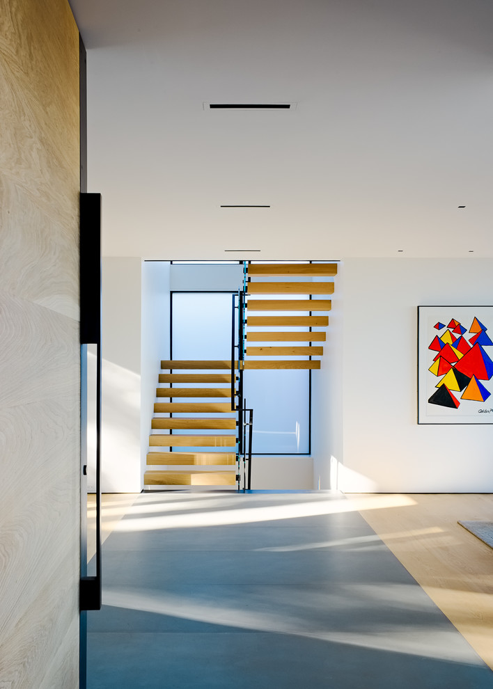 Design ideas for a modern wood u-shaped staircase in San Francisco with open risers and mixed railing.