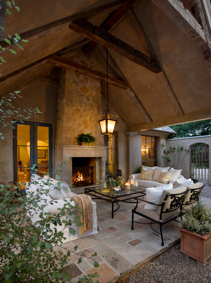 This is an example of a mediterranean patio in Santa Barbara with a fire feature.