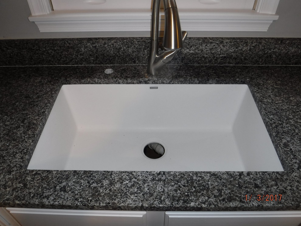 Home design - mid-sized transitional home design idea in Baltimore with an undermount sink, white cabinets, granite countertops and stone slab backsplash