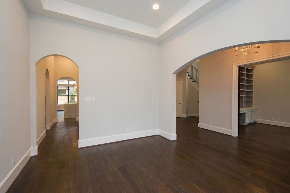 Photo of a large contemporary separate dining room in Houston with grey walls, dark hardwood floors and brown floor.