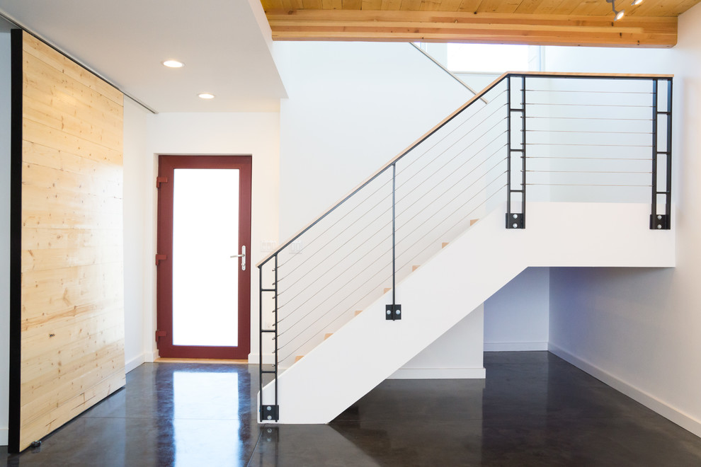 Design ideas for a small modern wood u-shaped staircase in Portland with open risers.
