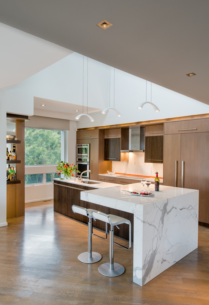 Design ideas for a contemporary single-wall open plan kitchen in DC Metro with flat-panel cabinets, medium wood cabinets, white splashback, panelled appliances, medium hardwood floors and with island.