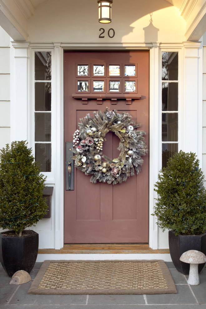 Inspiration for a traditional entryway in New York with a dark wood front door.