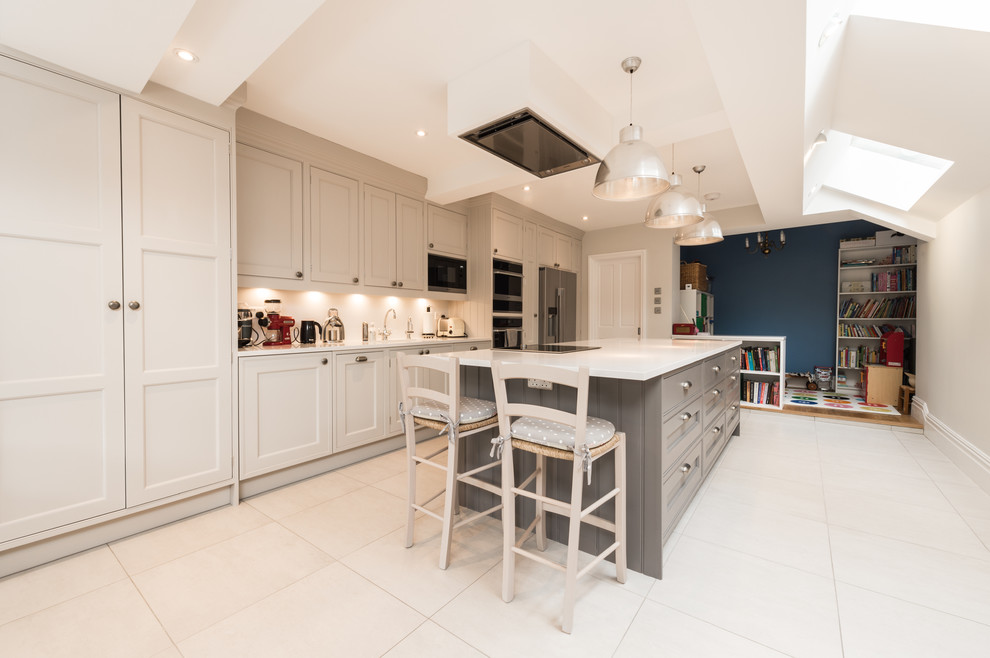 Inspiration for an expansive scandinavian galley eat-in kitchen in Hertfordshire with grey cabinets, quartzite benchtops, white splashback, stone slab splashback, with island, an undermount sink, raised-panel cabinets, stainless steel appliances and ceramic floors.