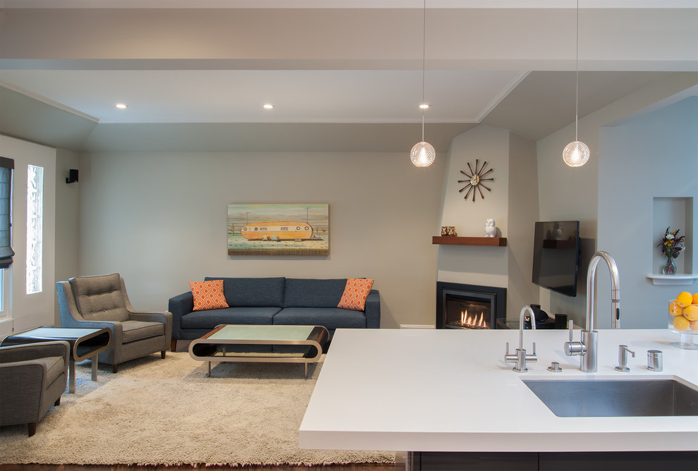 Photo of a small midcentury formal open concept living room in San Francisco with grey walls, a corner fireplace, a plaster fireplace surround and a wall-mounted tv.