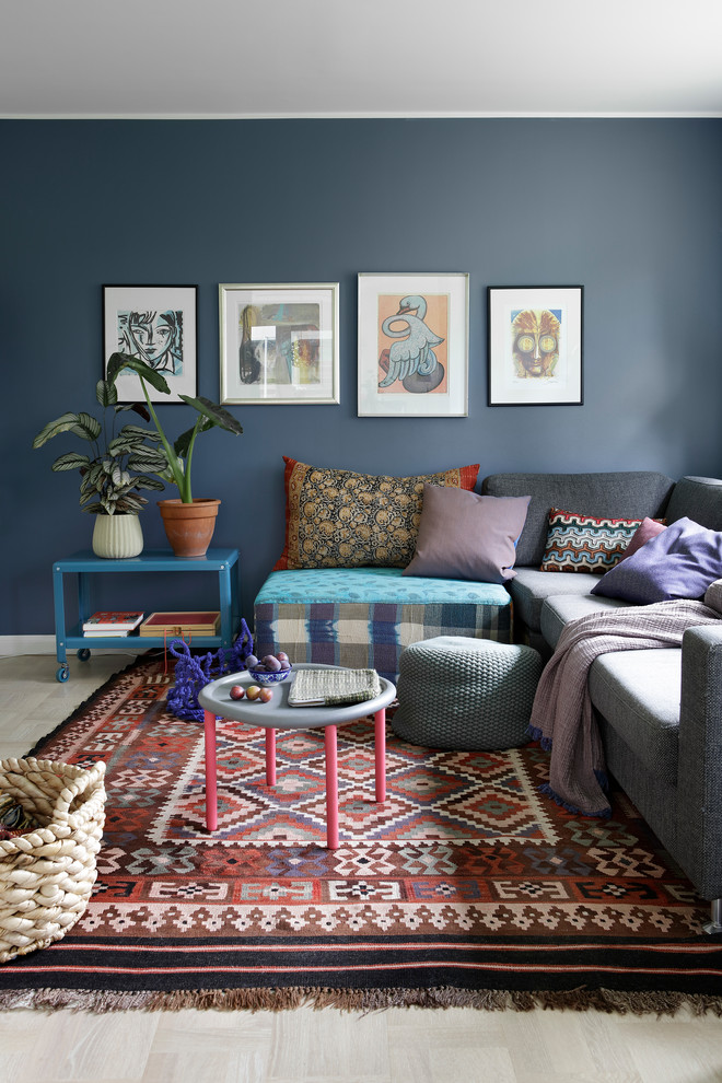 Design ideas for an eclectic living room in Copenhagen with blue walls, light hardwood floors and beige floor.