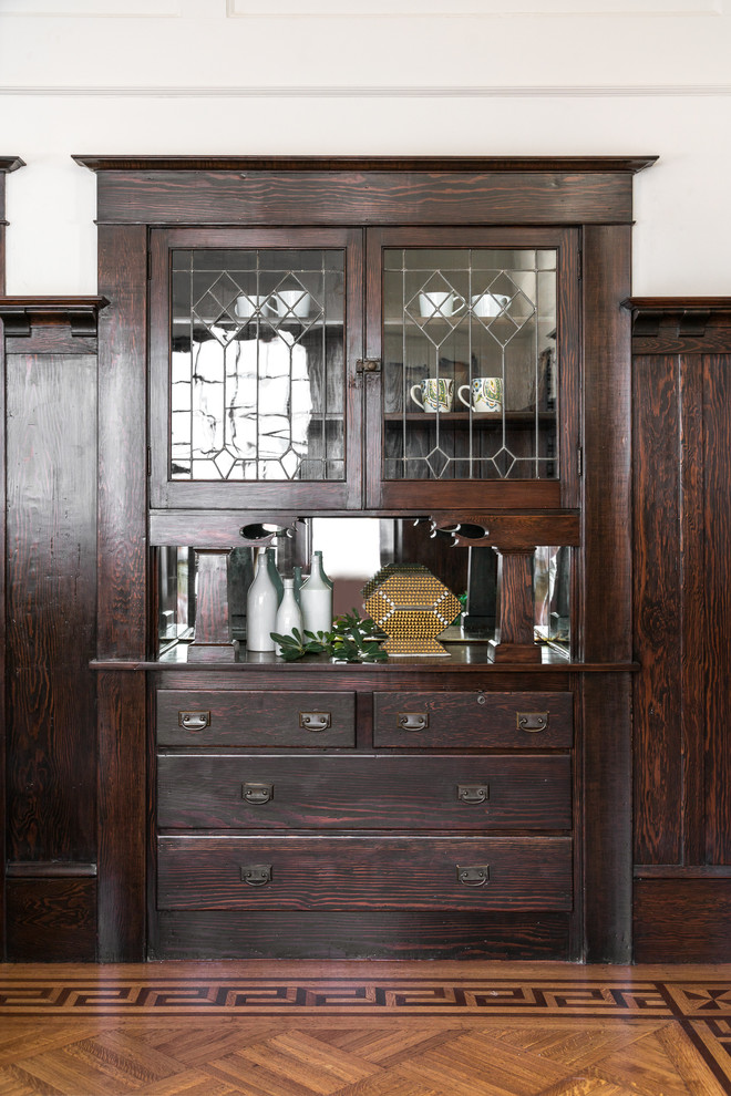 Mid-sized ornate light wood floor and brown floor enclosed dining room photo in Sacramento with white walls